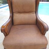 Pair of aged leather armchairs with seat and firm backrest with cherry wood frame