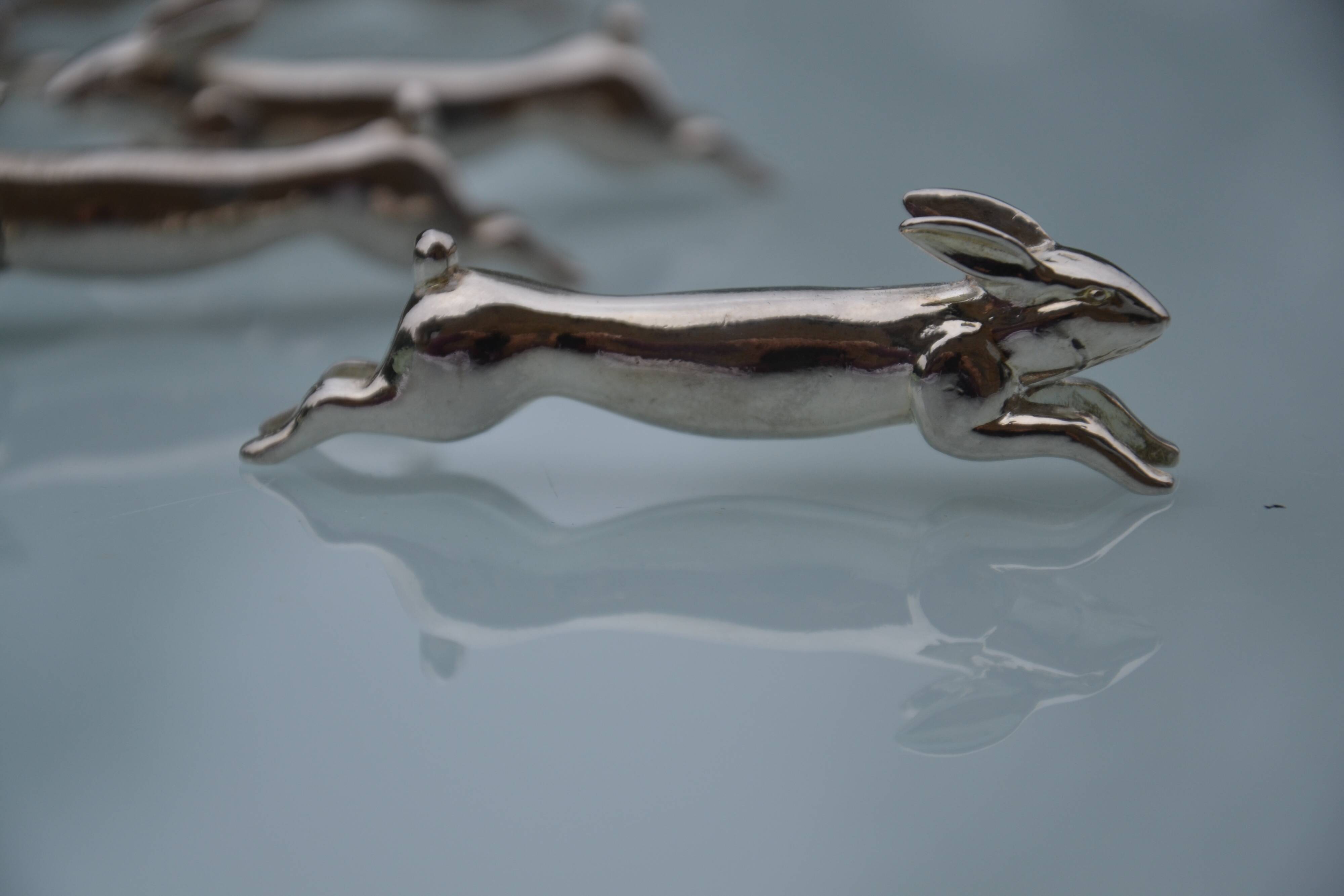12 silver-plated metal "rabbit" knife rests