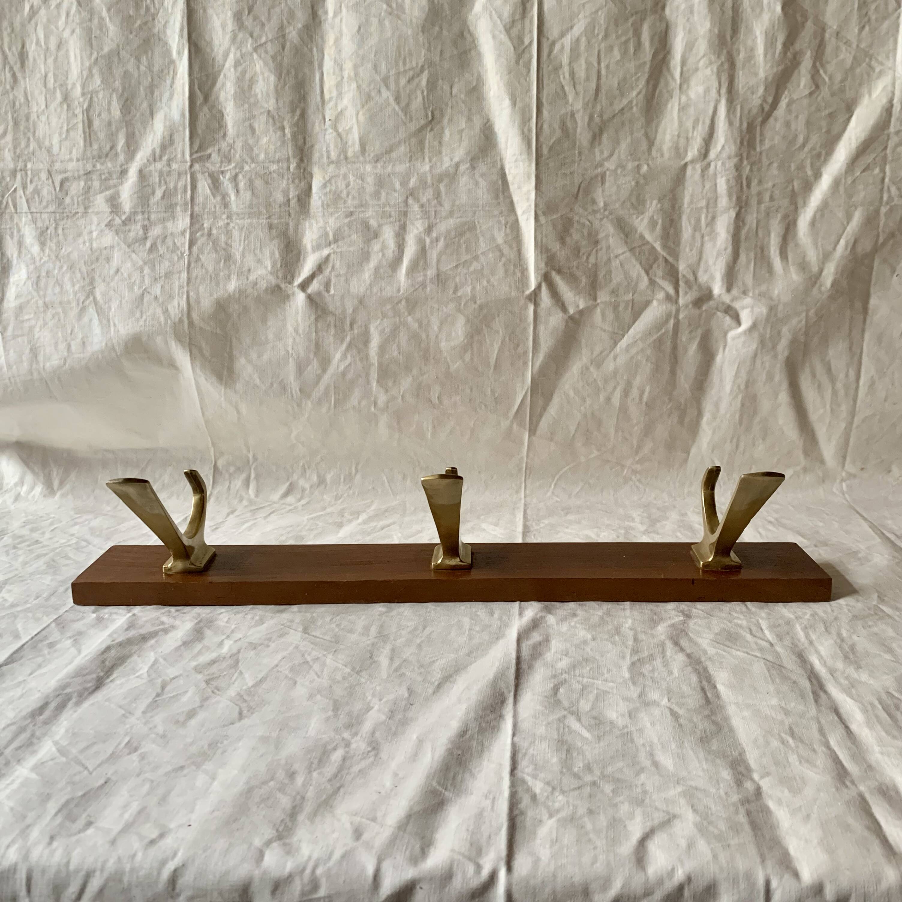Vintage wooden wall-mounted coat rack with 3 golden cast aluminum hooks