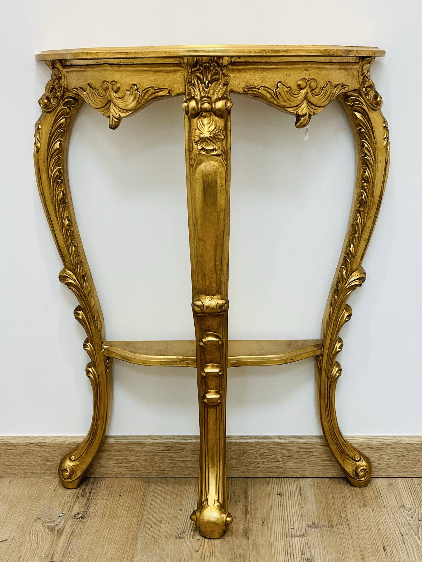 Golden console in Louis XV Rococo style made of resin.