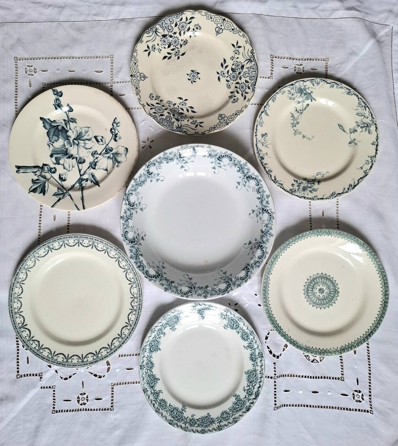 Old mismatched flat plates in iron earth earthenware accompanied by a dish