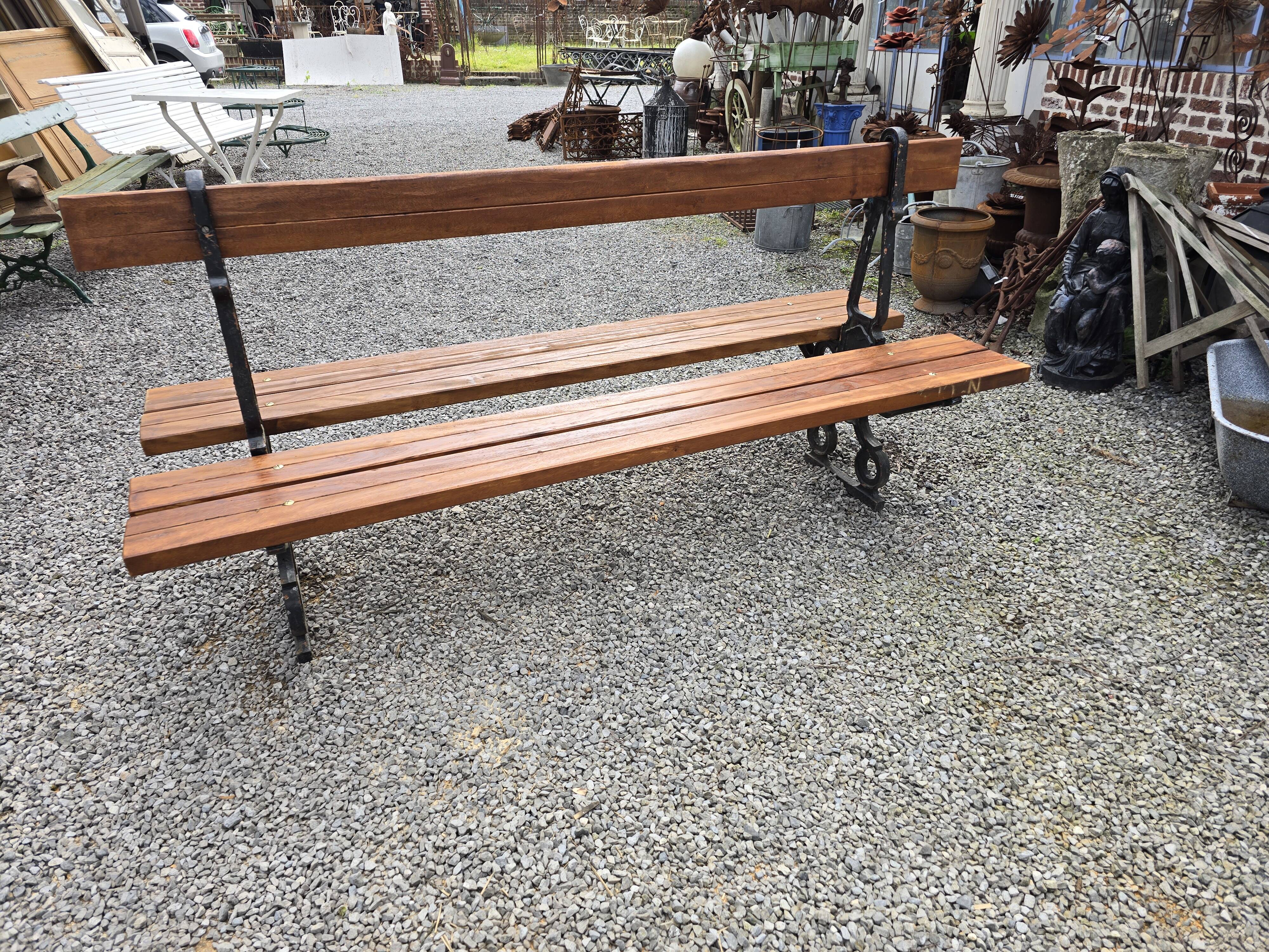 Antique double garden bench from the city of Paris in cast iron and wood