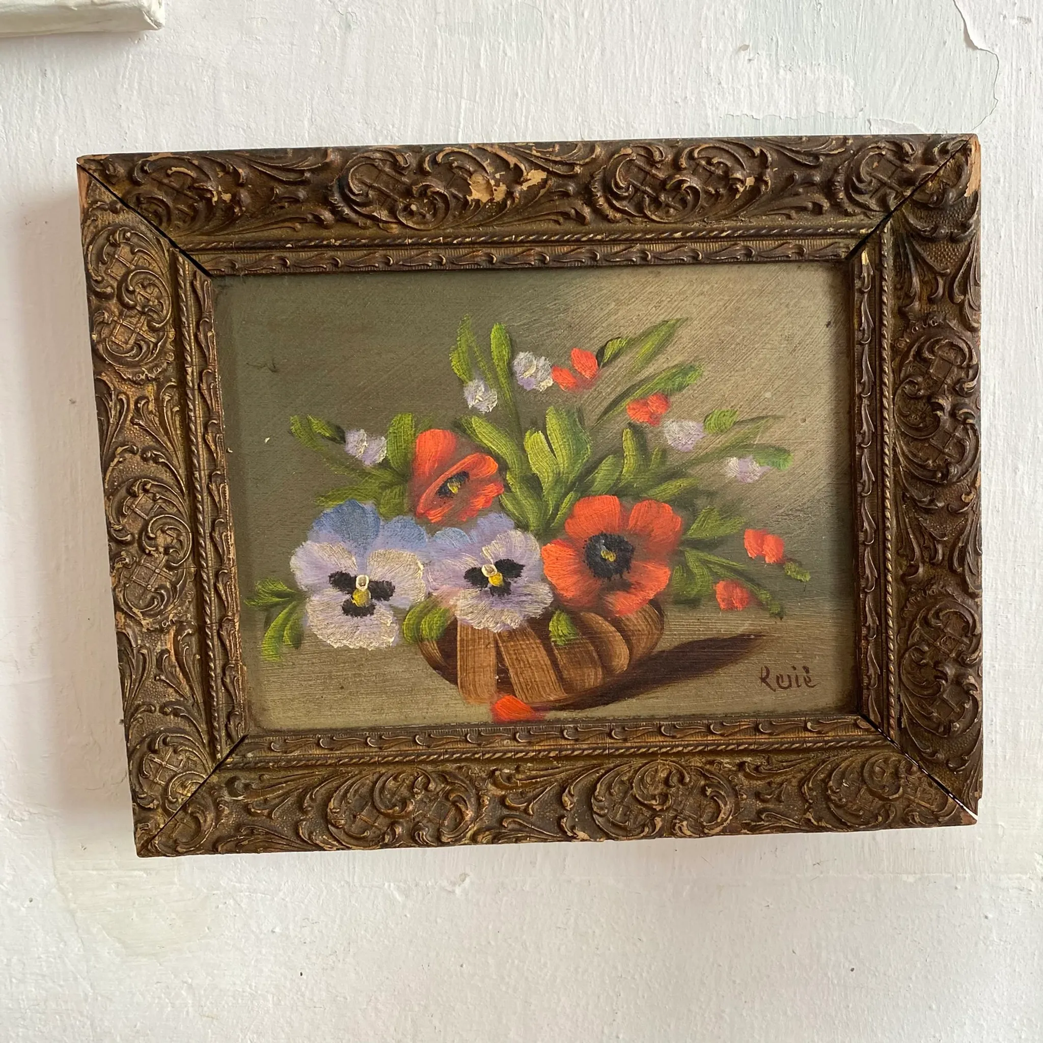 Old painting of a bouquet of pansies and poppies.