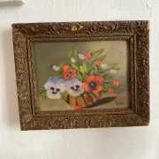 Old painting of a bouquet of pansies and poppies.