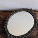 Miroir ovale en métal style baroque