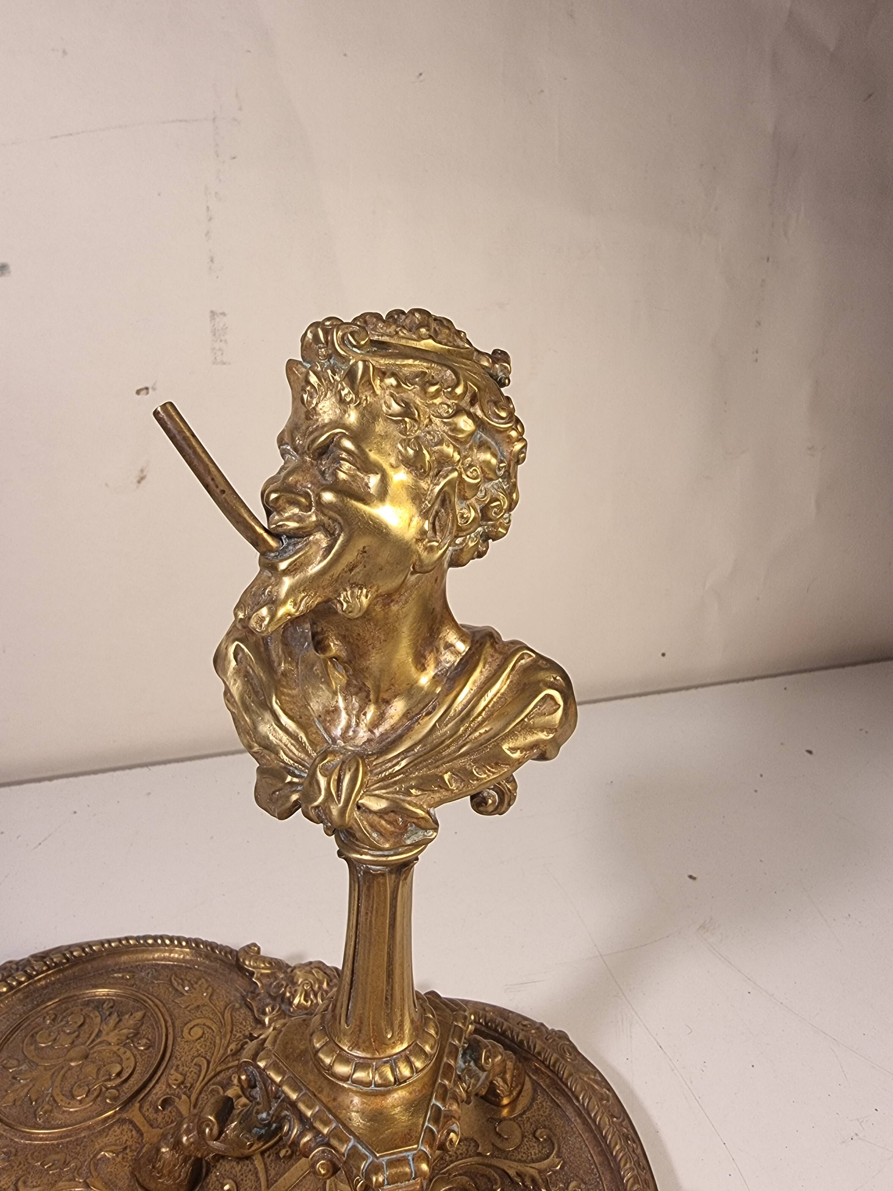 An antique bronze cigar lighter.
