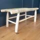 Natural wood bench and braided doum.