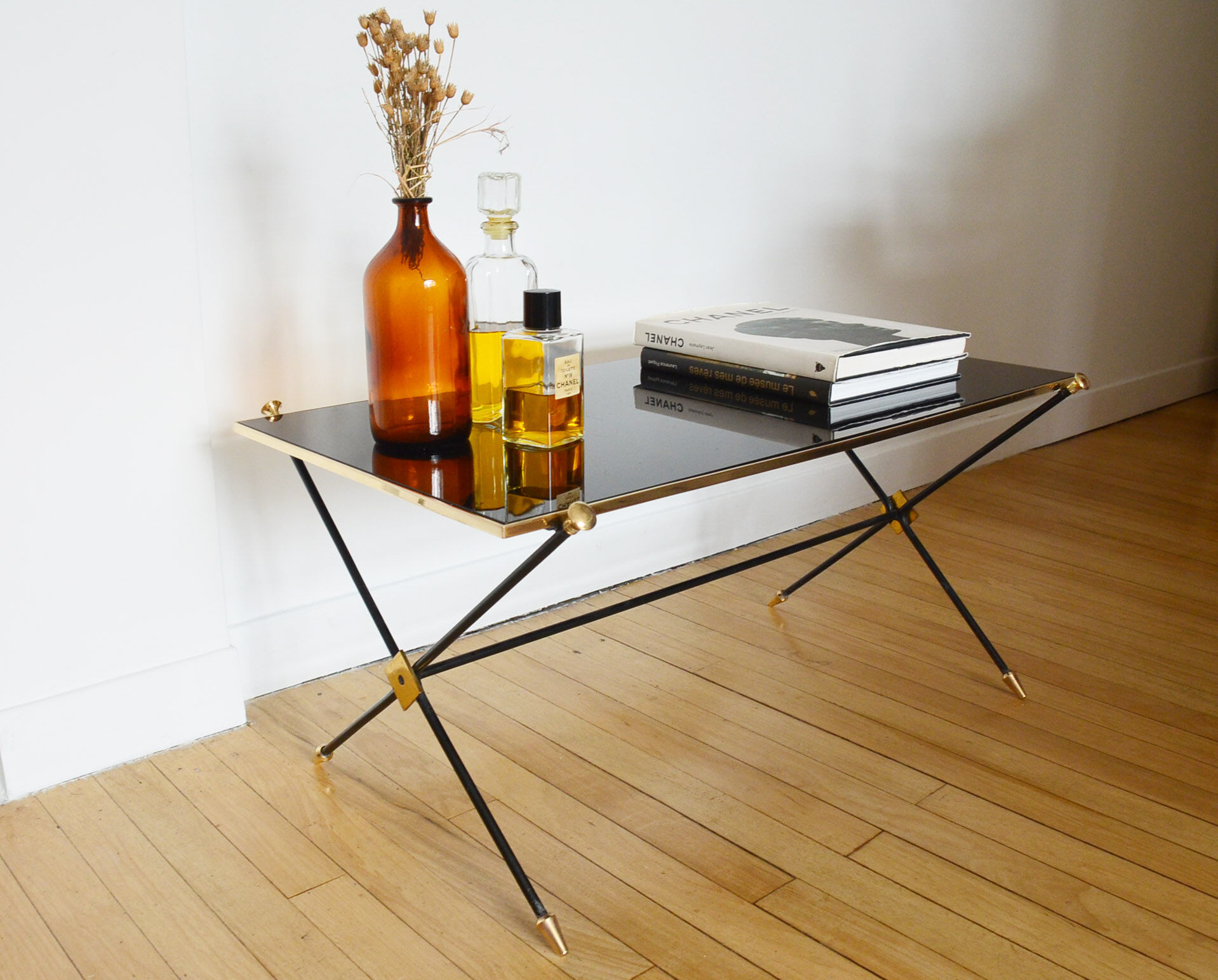 Black glass and brass coffee table in the 1960s