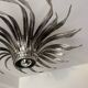 Silver wrought iron sunburst wall light from the 1960s.