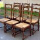 6 solid wood chairs in dark oak with a glossy finish and straw.