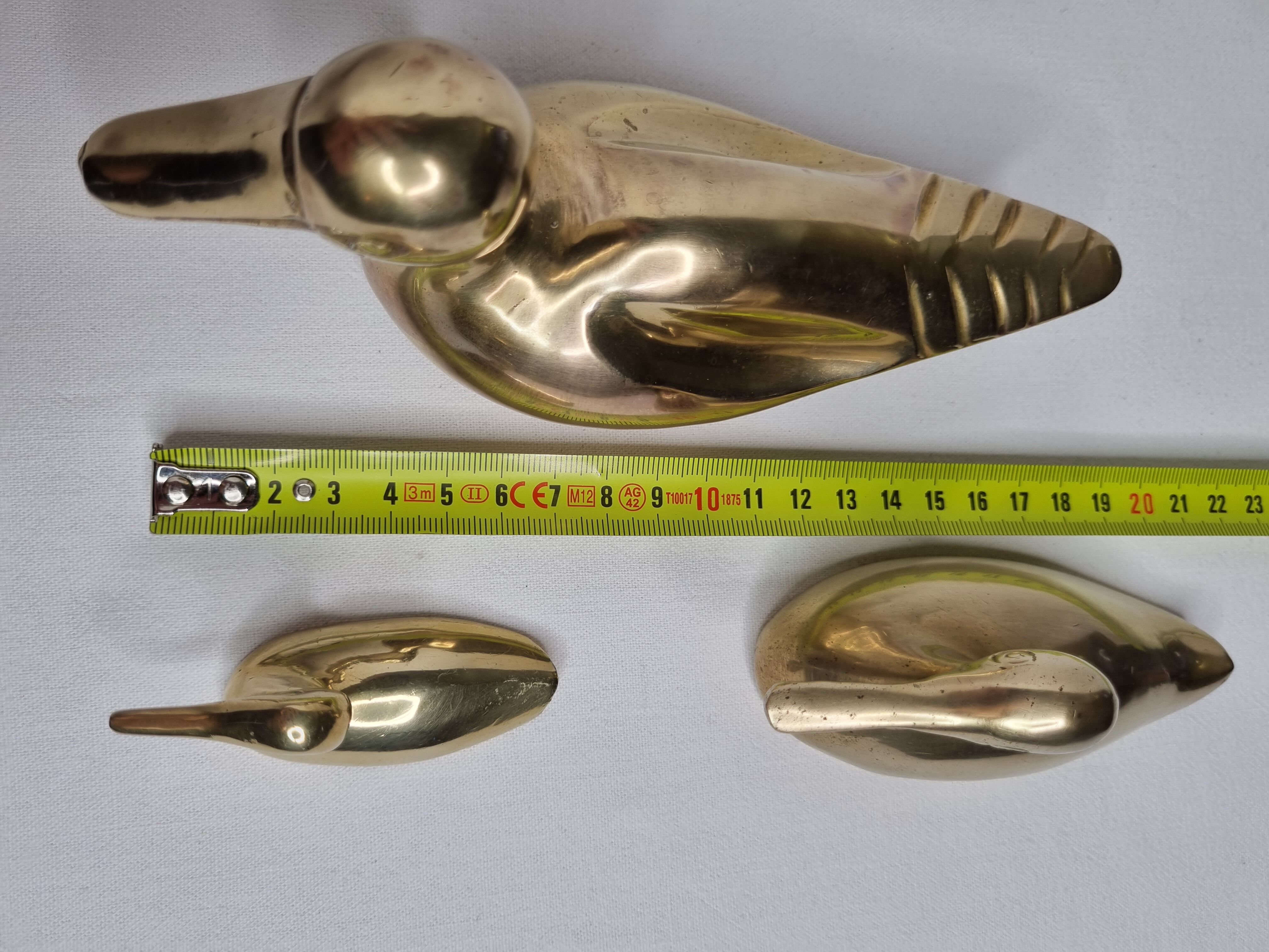 Set of three brass ducks