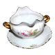 Vintage pouring sauce boat in floral porcelain with gilding.