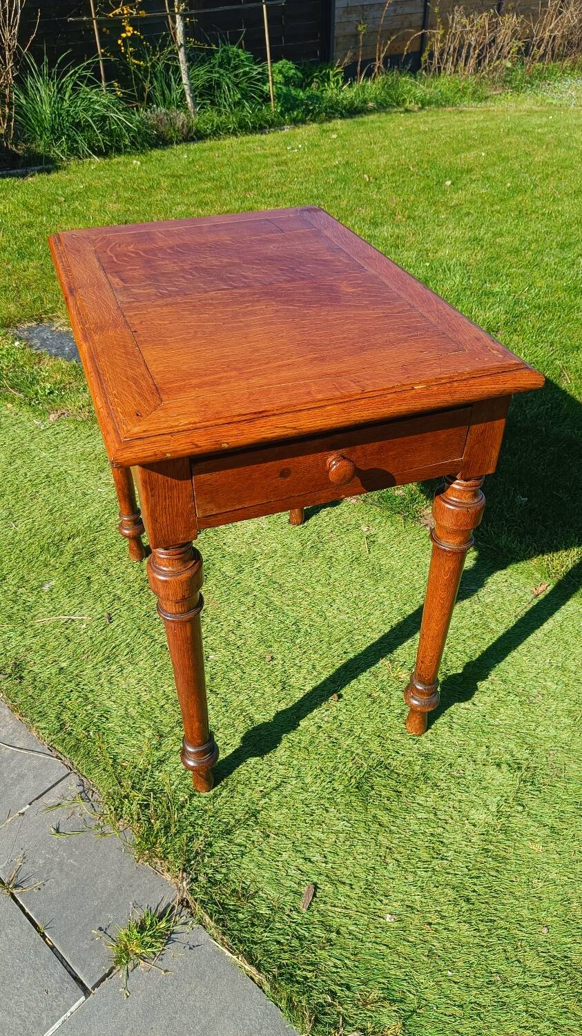 Antique solid wood table with a through drawer.