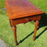 Antique solid wood table with a through drawer.