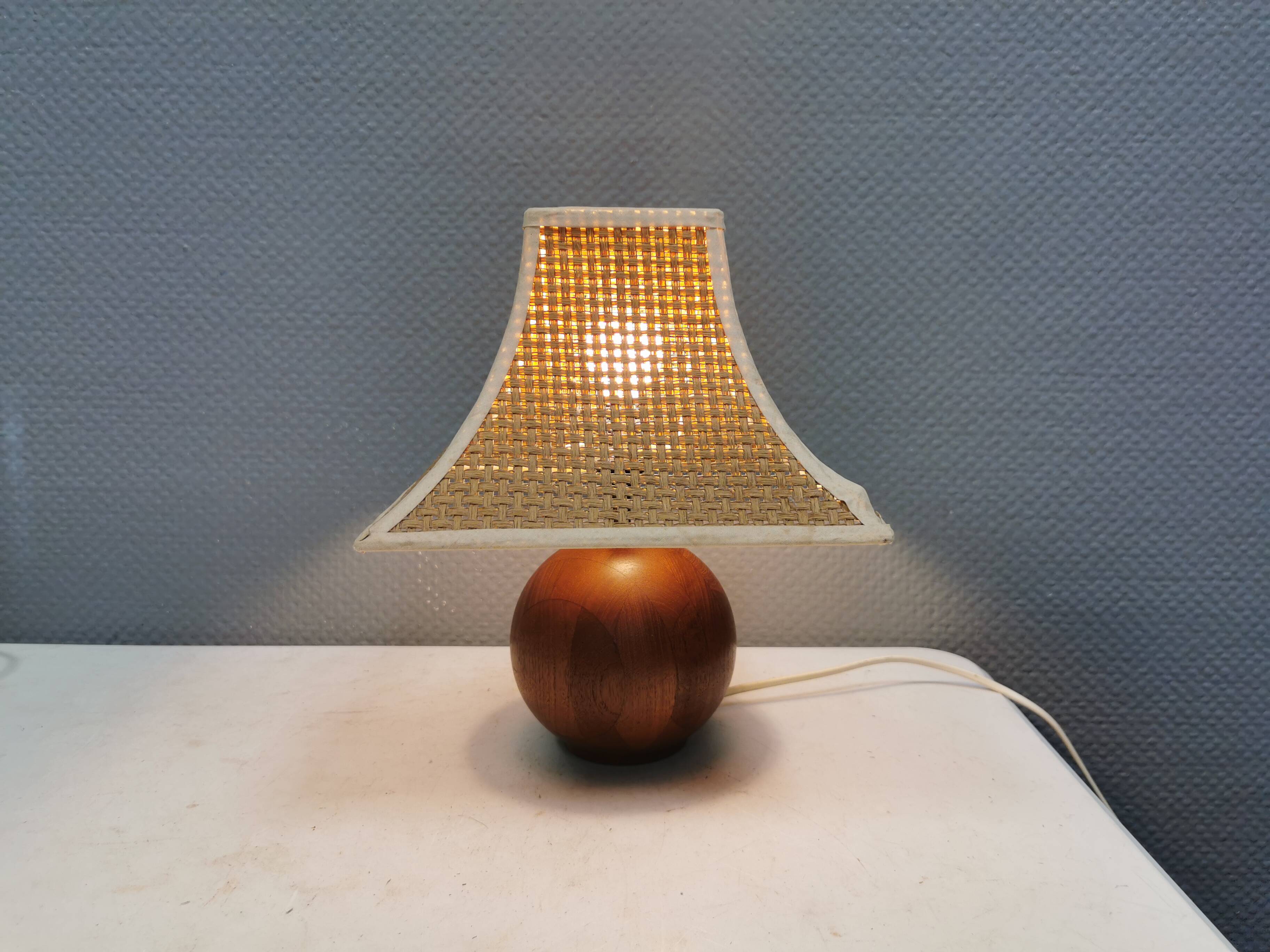 Very rare table lamp in turned teak wood with original braided shade. 1970s
