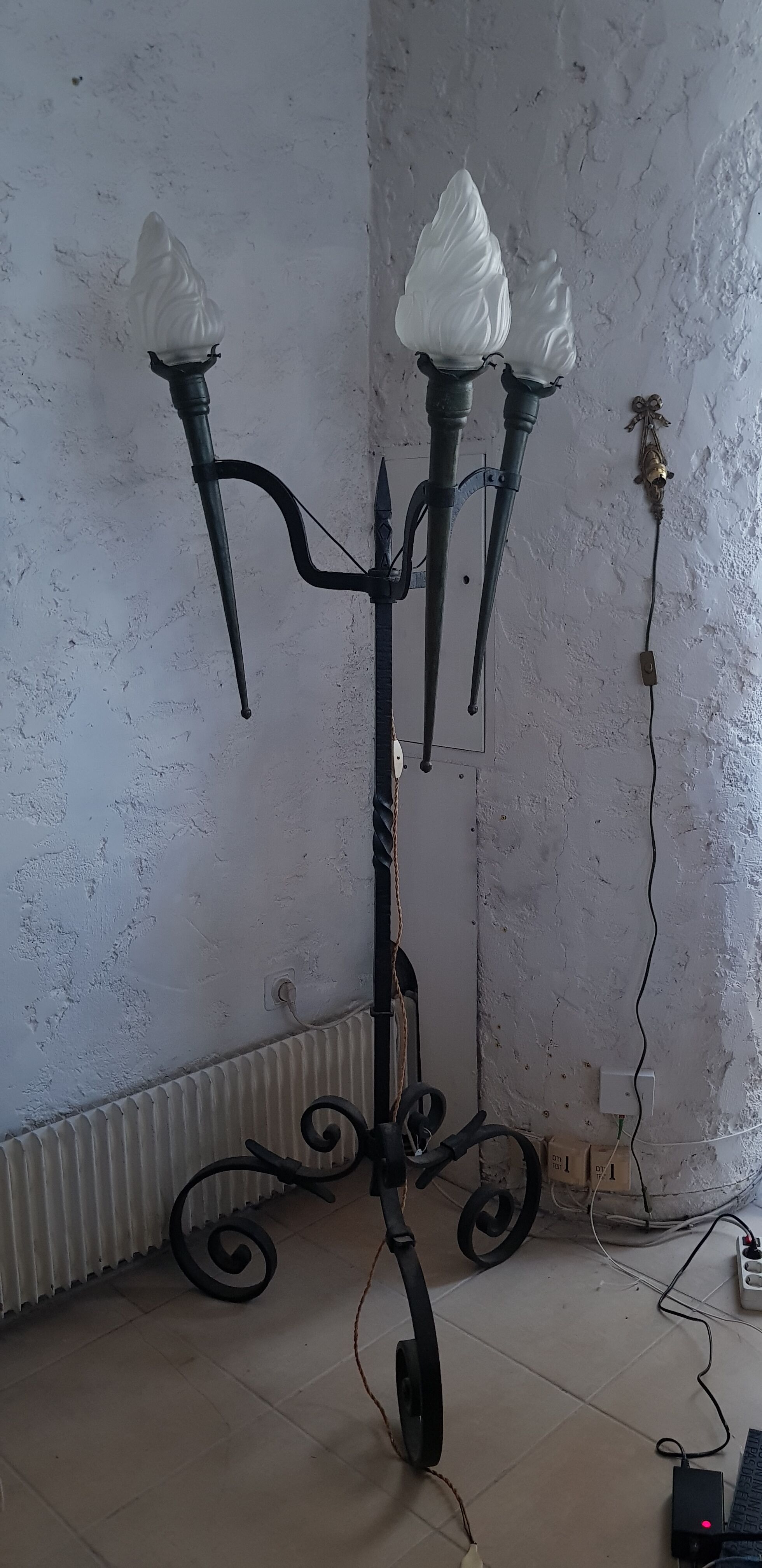 Old wrought iron tripod lamppost