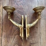 Pair of bronze wall sconces with outstretched arms and hands