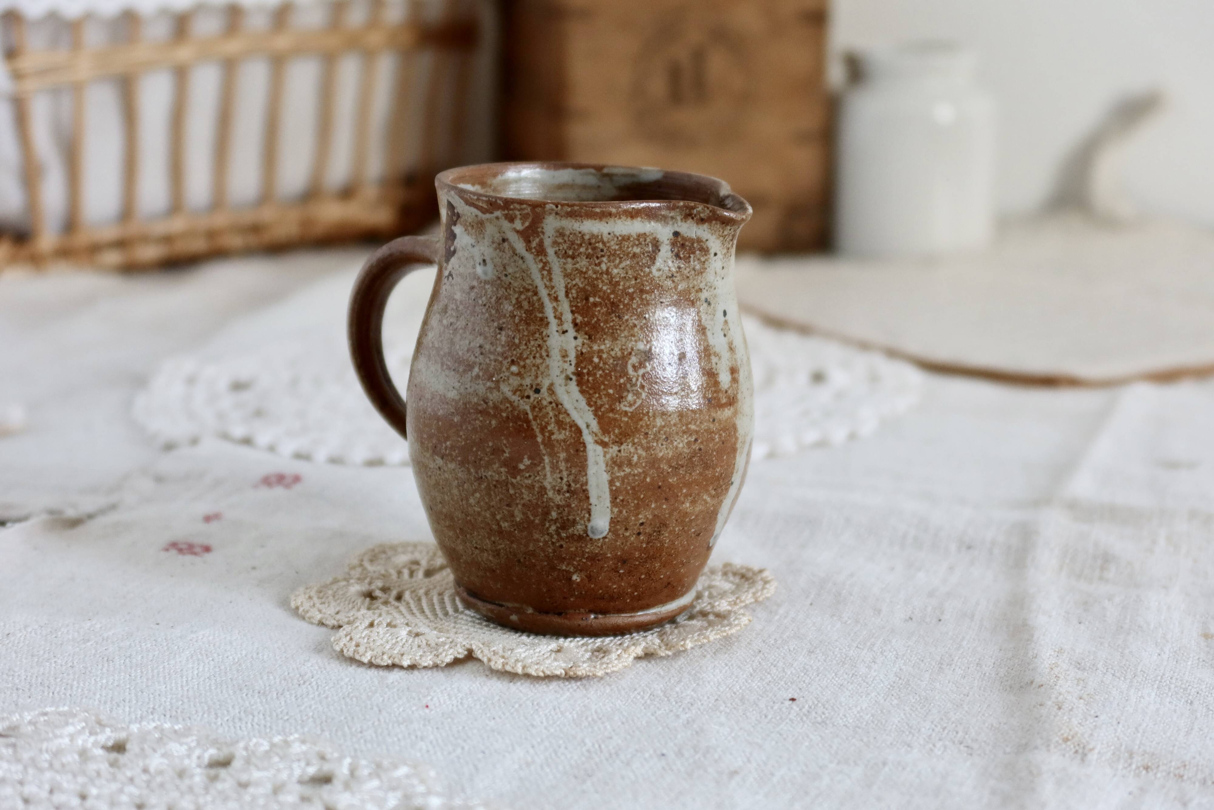 Small vintage hand turned ceramic milk jug with rustic glaze