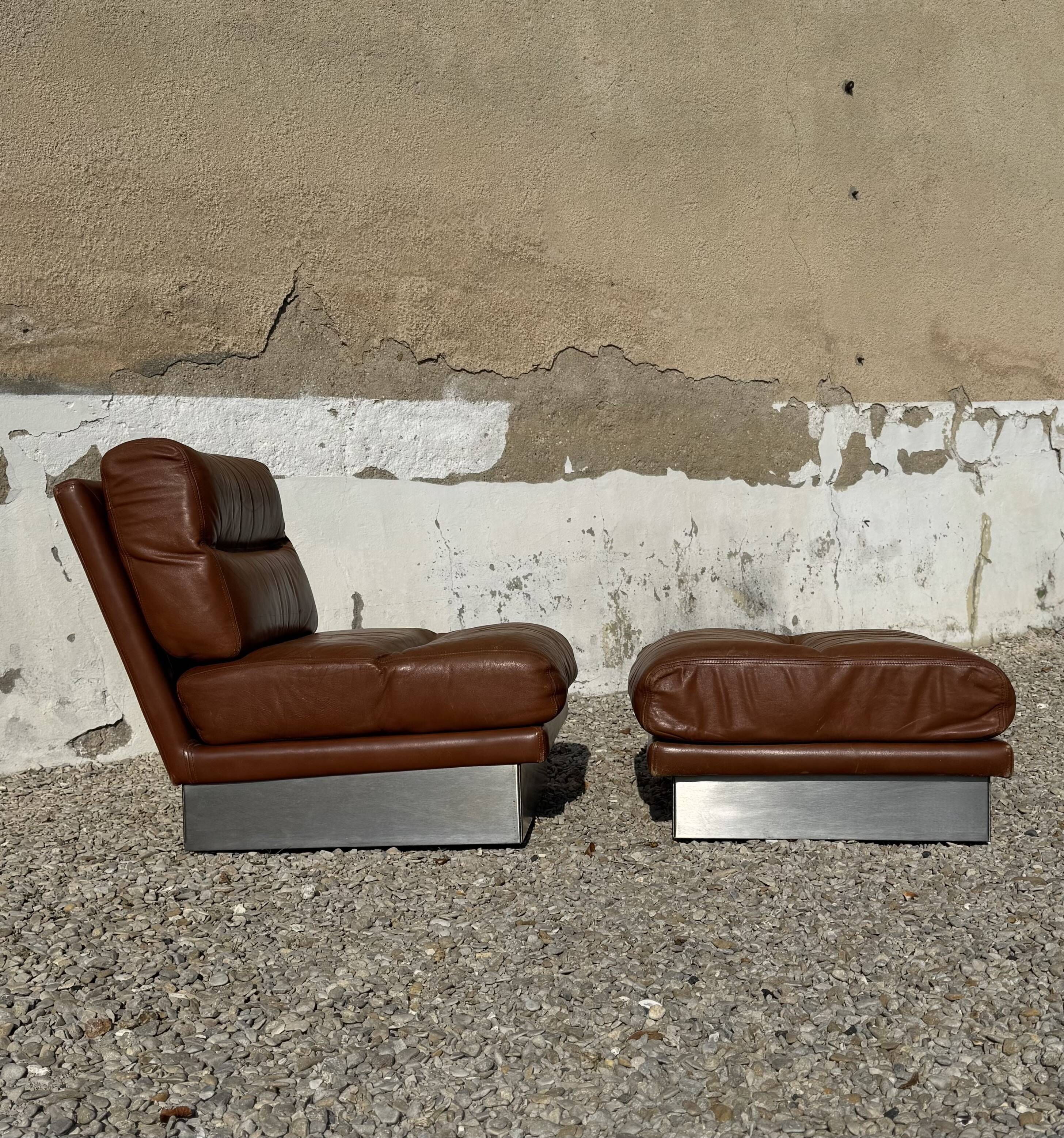2 armchairs and 1 ottoman in brushed aluminium and brown leather, France, 1970.