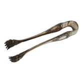 Antique metal sugar tongs in the shape of a lion's paw.