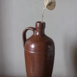 Vintage stoneware liqueur bottle with handle and spout.