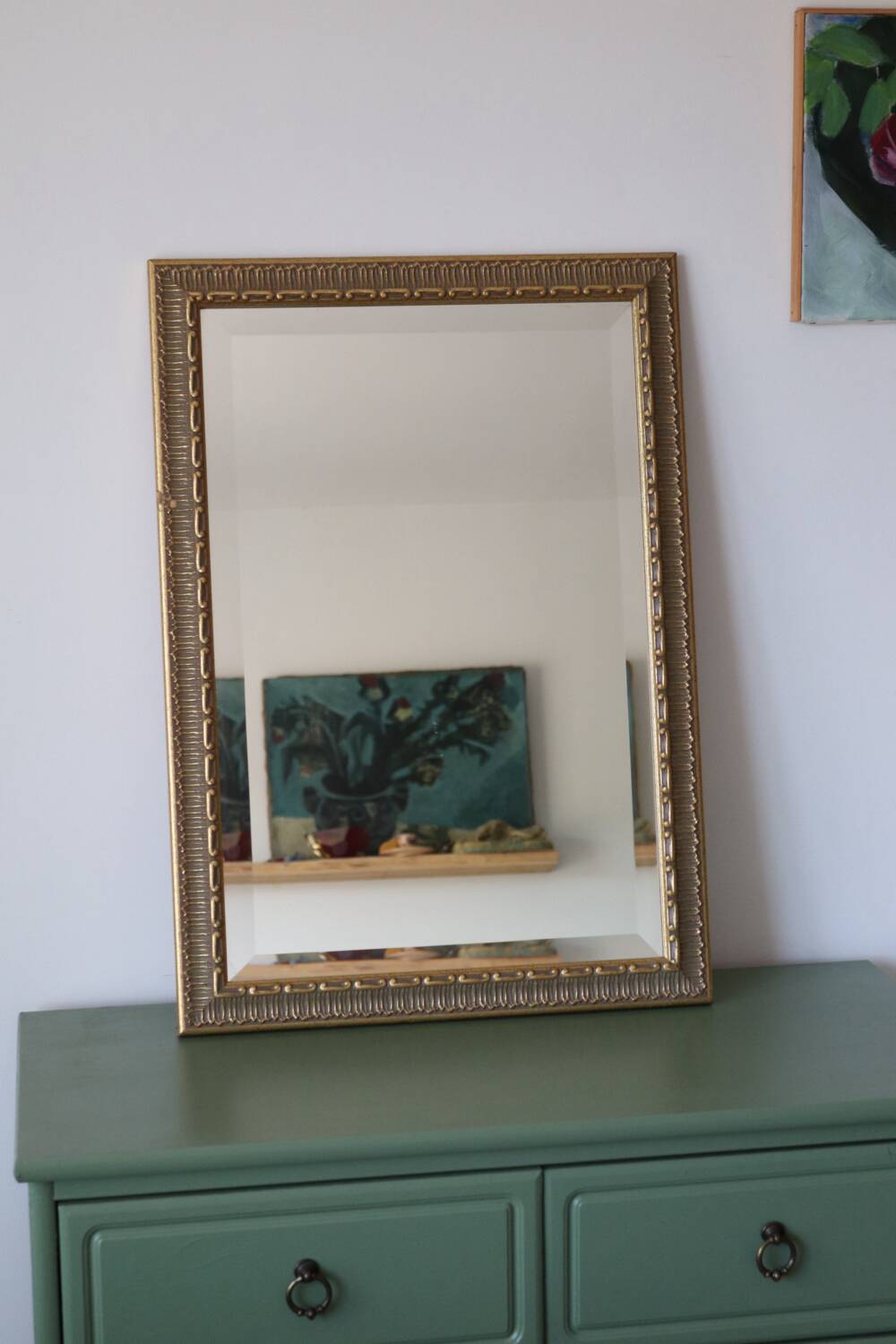 Rectangular gold mirror with moulded decoration.