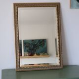 Rectangular gold mirror with moulded decoration.
