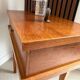 Vintage bedside table with tapered legs.