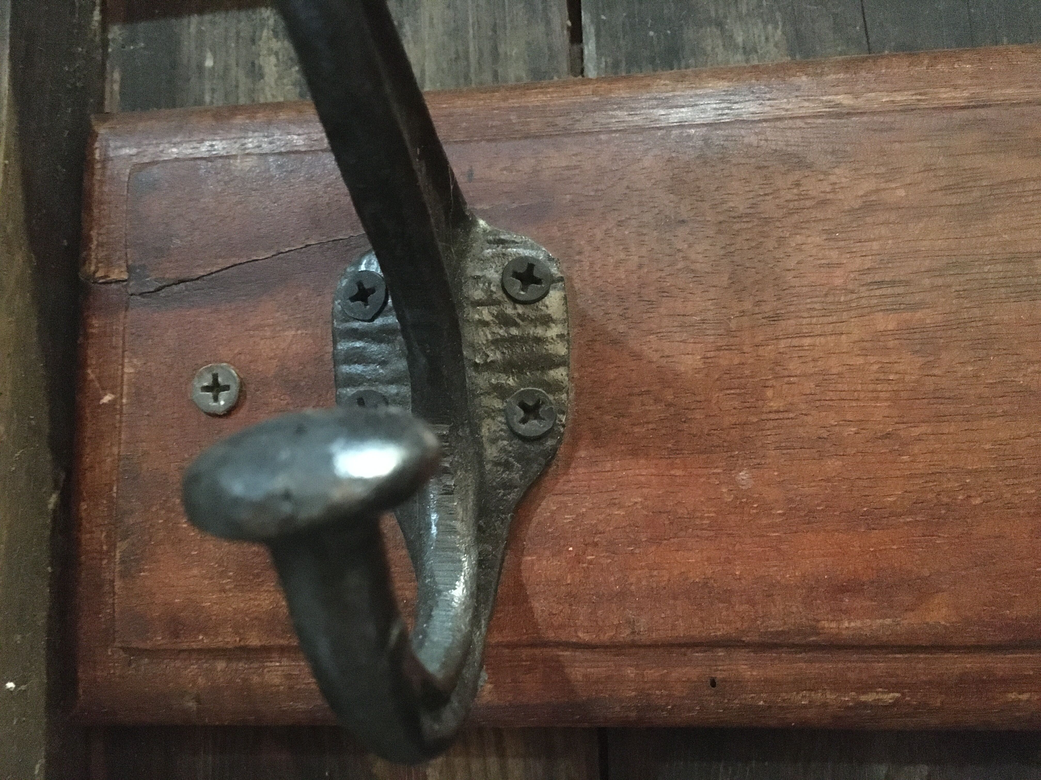 Metal patère on wood