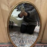 Oval mirror in gilded wood