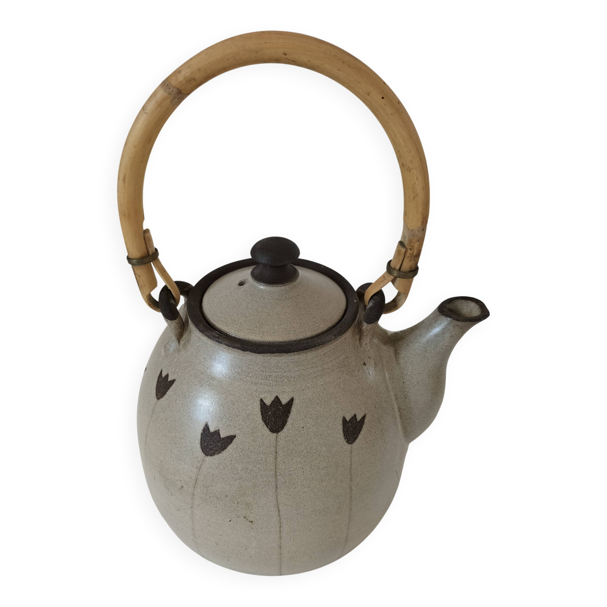 Beige stoneware teapot with stylized flowers and rattan handle