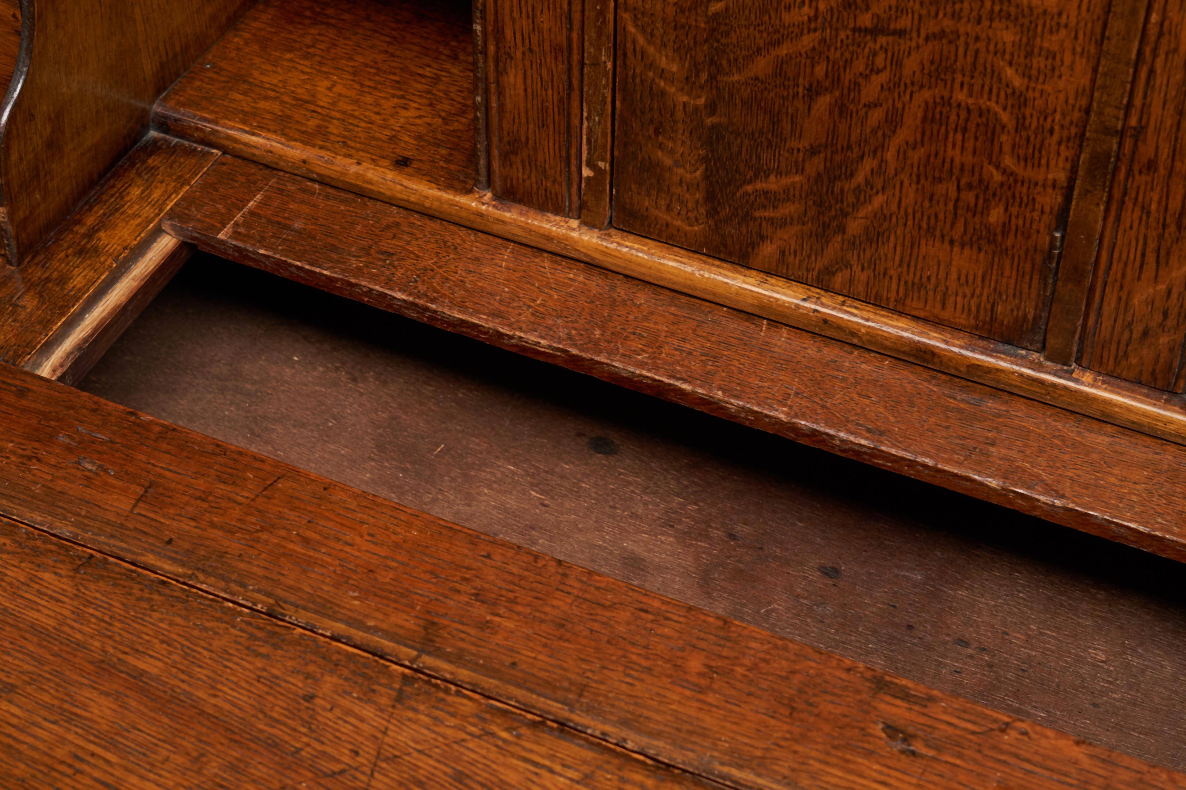 Antique English oak secretary with drop-down front.