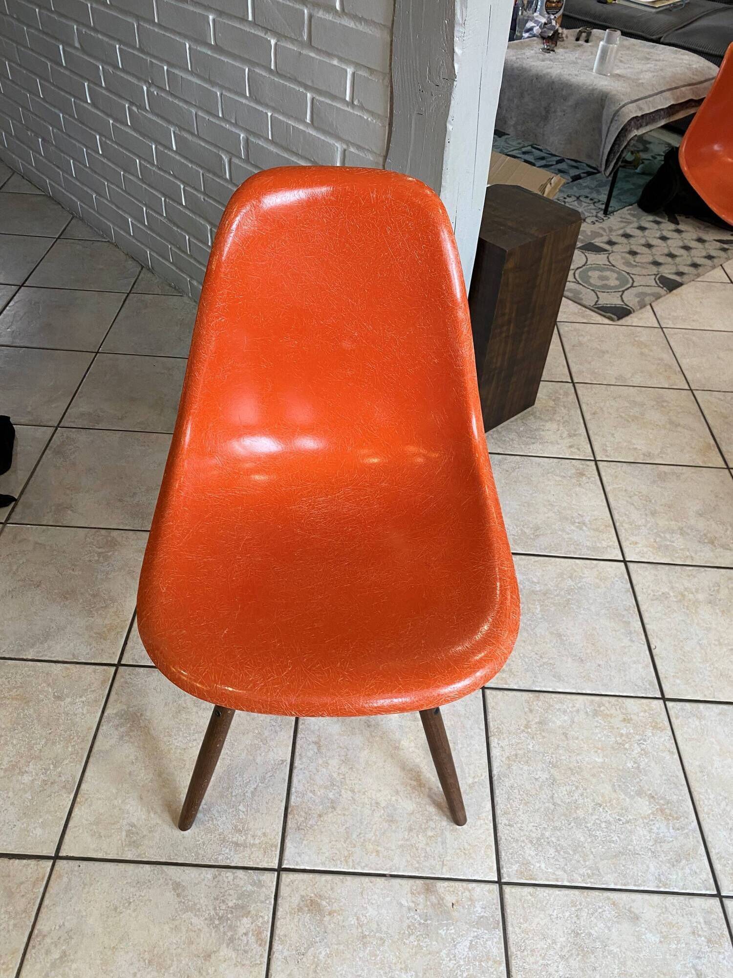A vintage 70s Eames Herman Miller DSW Fiber Red Orange Dowel Walnut Chair