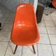 A vintage 70s Eames Herman Miller DSW Fiber Red Orange Dowel Walnut Chair