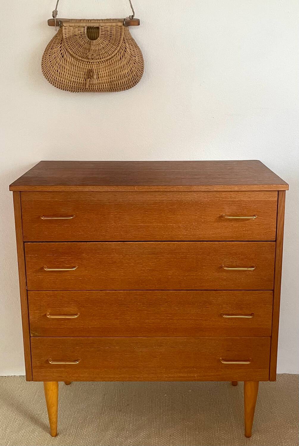 Vintage 1960s chest of drawers with covered handles.