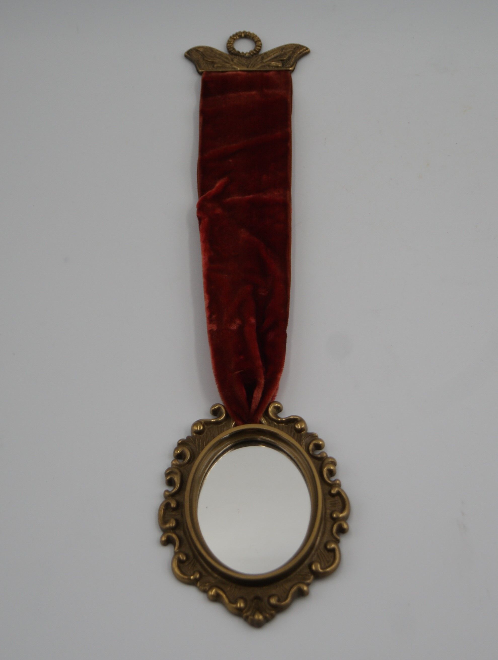 Vintage oval wall-mounted brass mirror