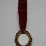 Vintage oval wall-mounted brass mirror