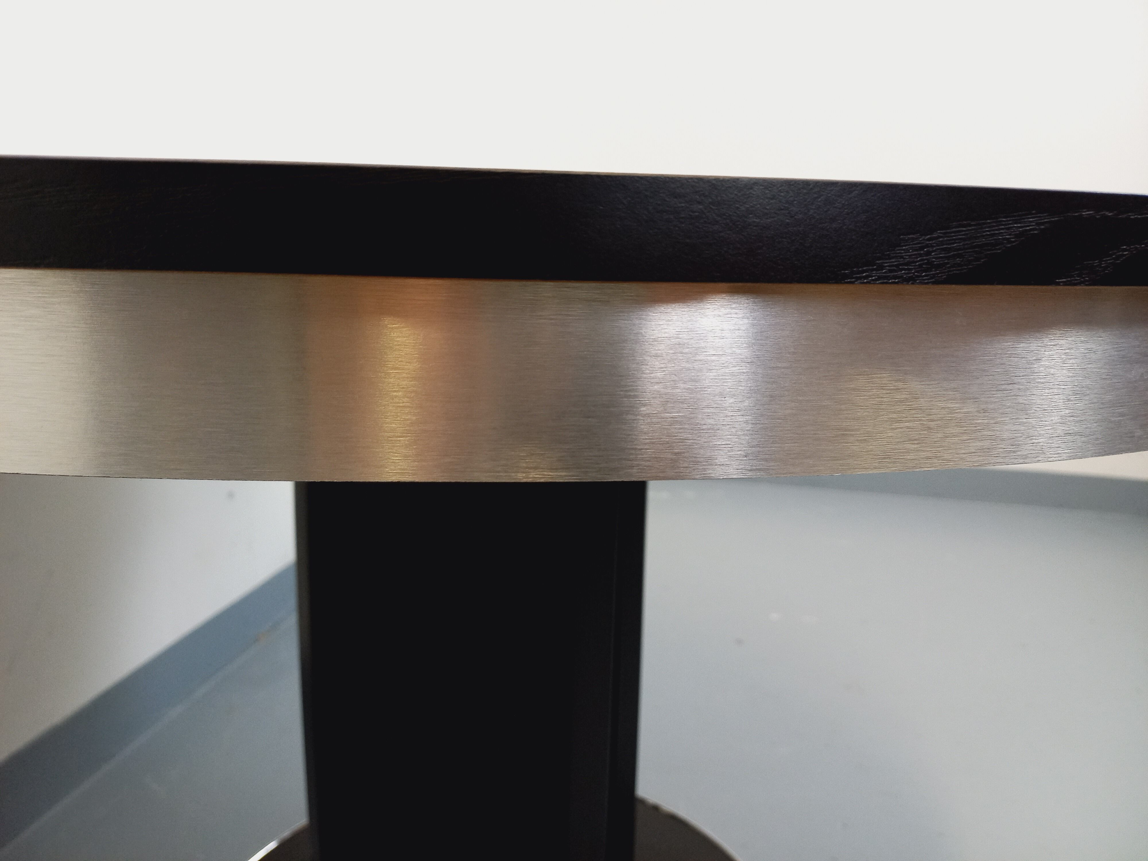 Vintage dining table in melamine with a black wood effect and chrome metal.
