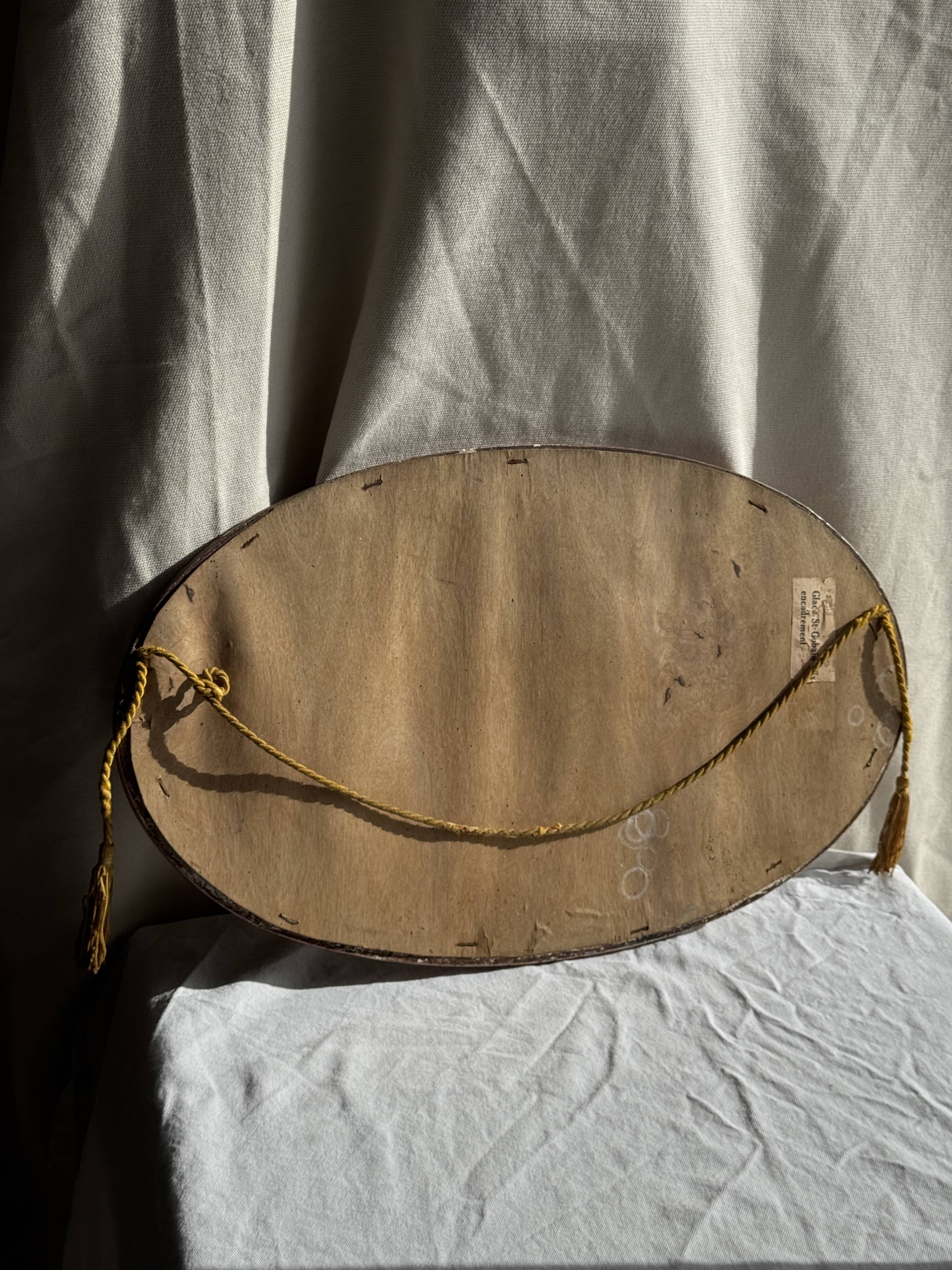Small oval Art Deco mirror in brown and gold 33x54.