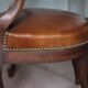 Barber chair in wood and leather with adjustable headrest, office chair.
