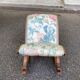 Kneeling prayer desk with rocking footrest in solid wood, curule style & floral fabric.