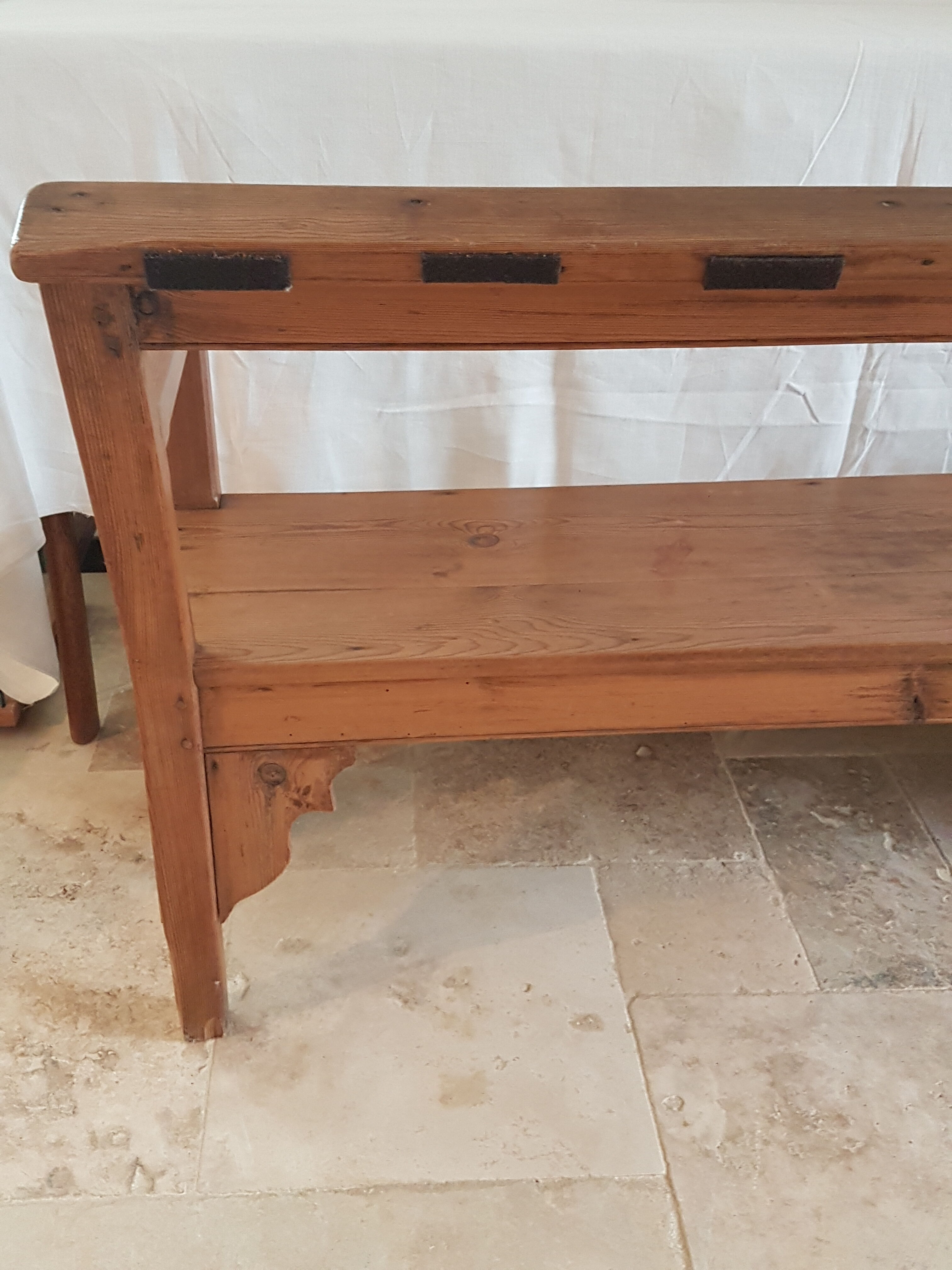Church bench in fir tree with armrests