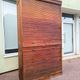 Vintage 1940s secretary desk with wooden curtains, storage, and shutters.