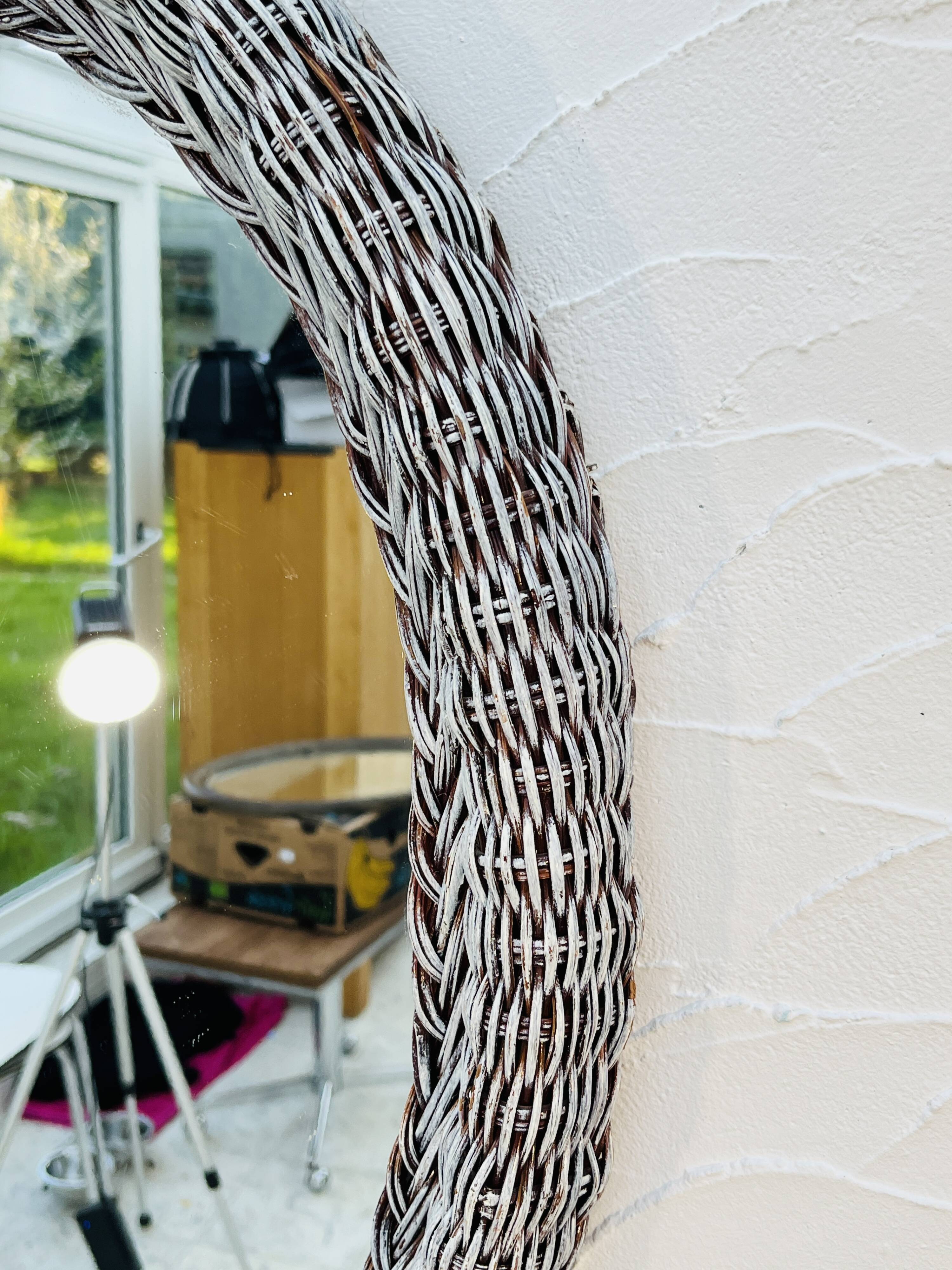 Vintage oval wicker mirror from the 1960s.