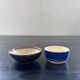 A pair of butter dishes signed HB Quimper.