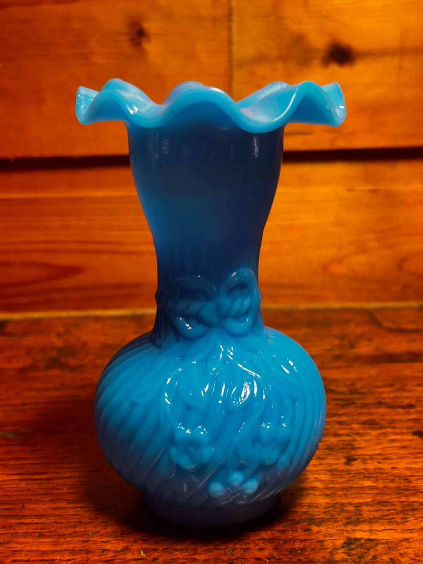 Blue opaline vase, opaque glass, wavy neck/rim, relief decoration of a bow.