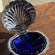 Vintage silver-plated shell butter dish with blue bowl.