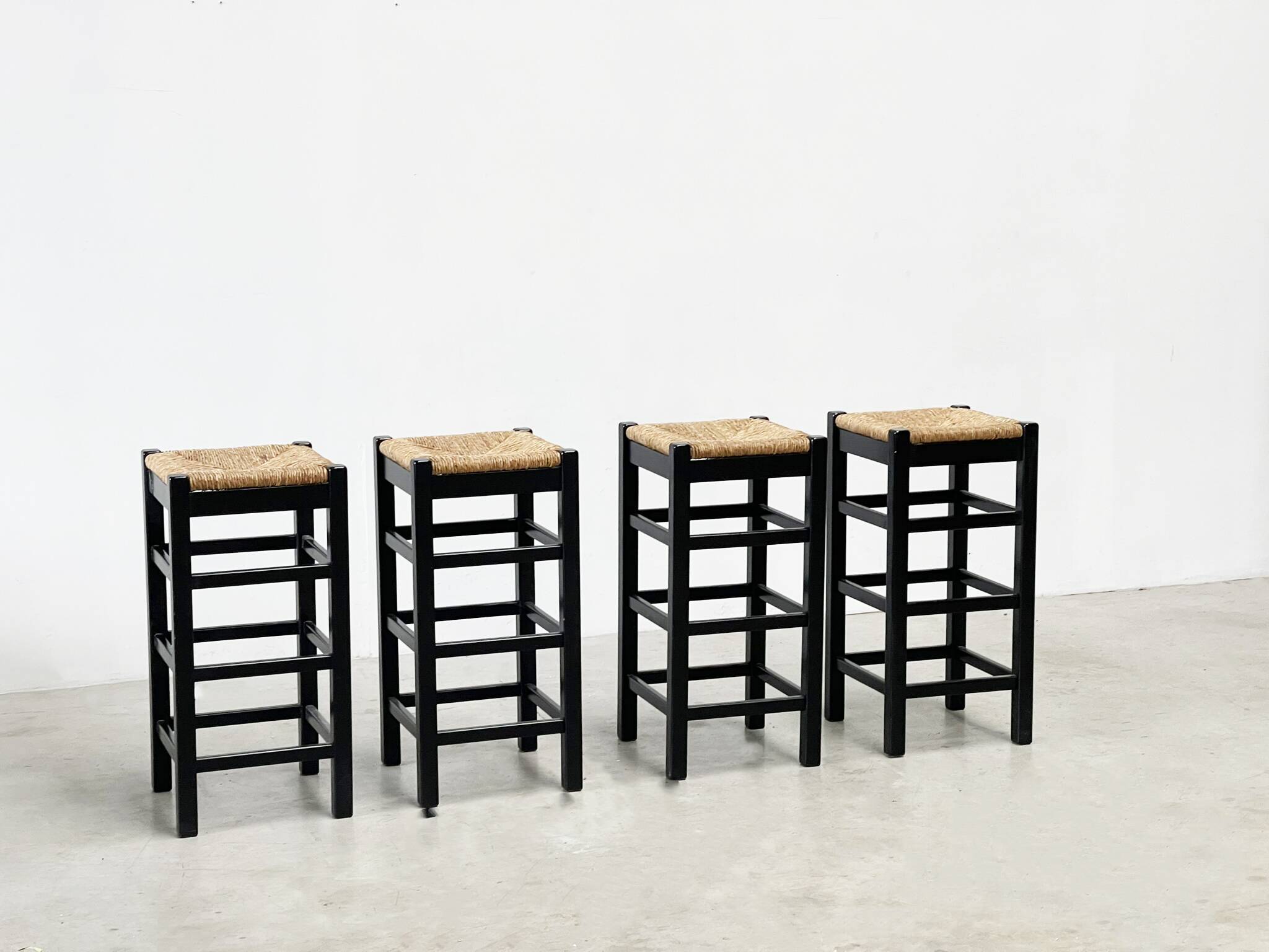 set of four rattan and wood barstools