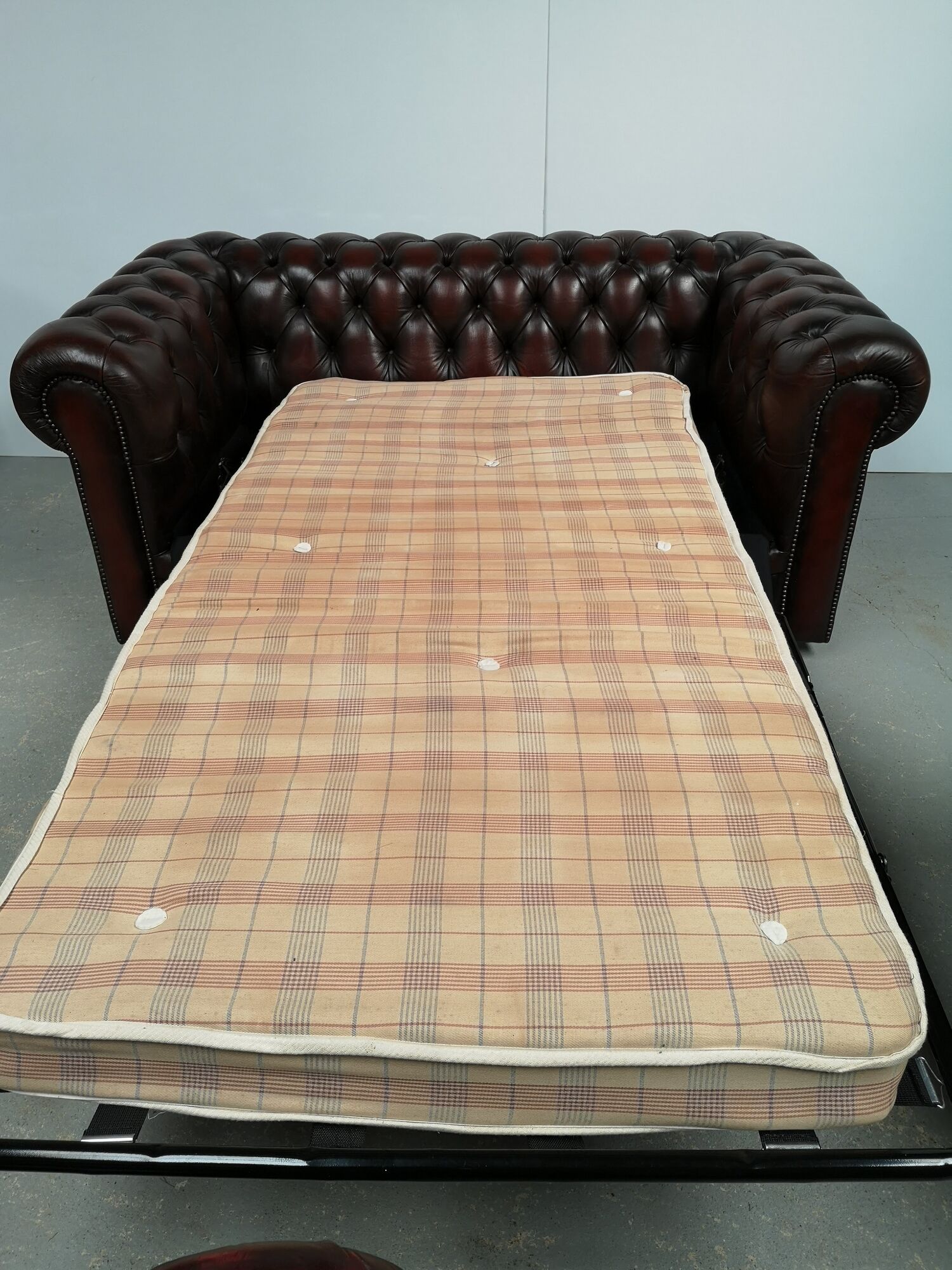 Convertible leather chesterfield sofa