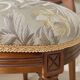 Antique Louis XVI style chair in wood and floral fabric.